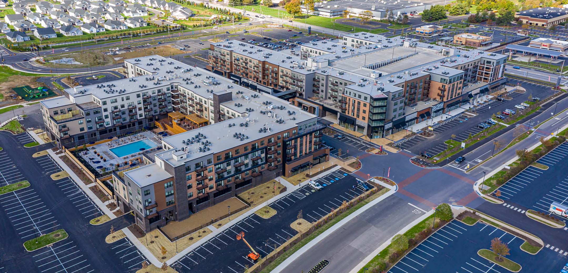 An aerial shot of the Promenade at Upper Dublin building, showcasing the large layout, parking amendments, and general area.