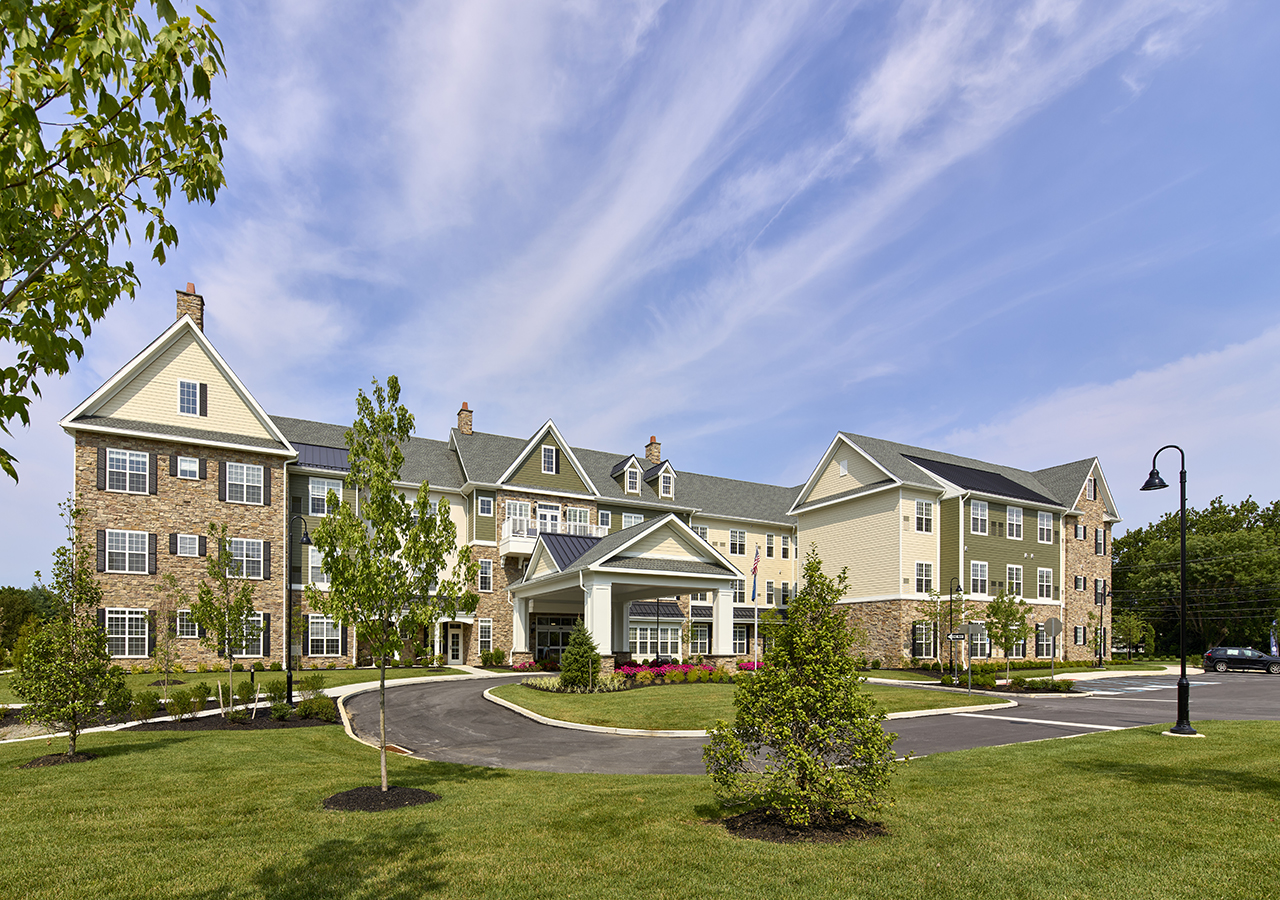 An exterior of Capitol Seniors Housing Exton Senior Living Community with a landscaped yard in front.