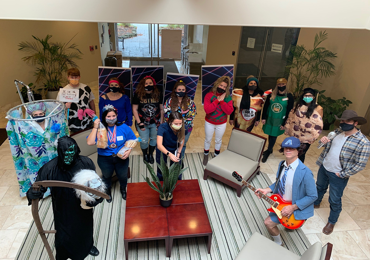 A group of IMC employees dressed up in various Halloween costumes.