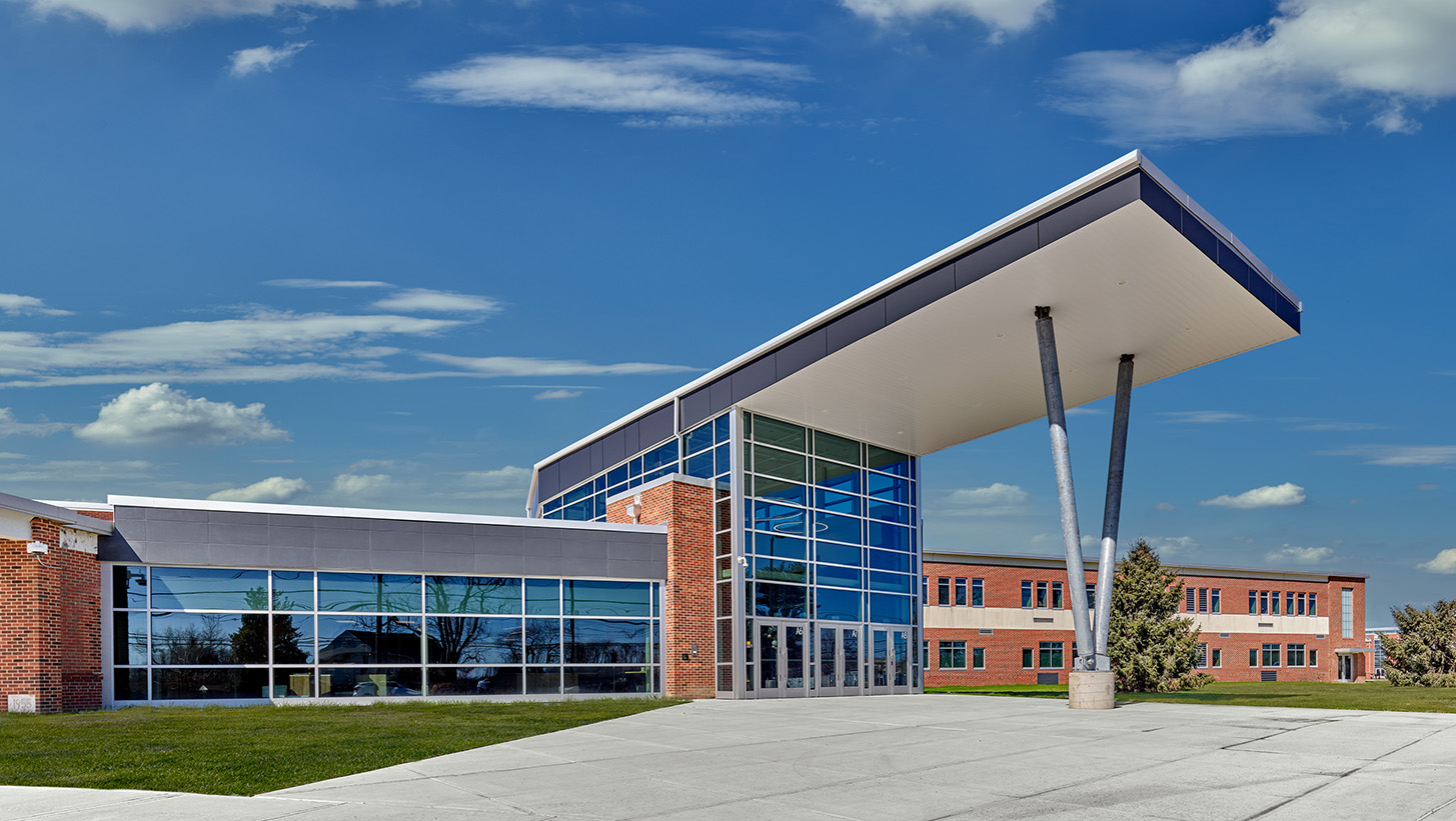 The exterior of Ben Franklin Middle School featuring an entryway to the front of the school with a glass windows