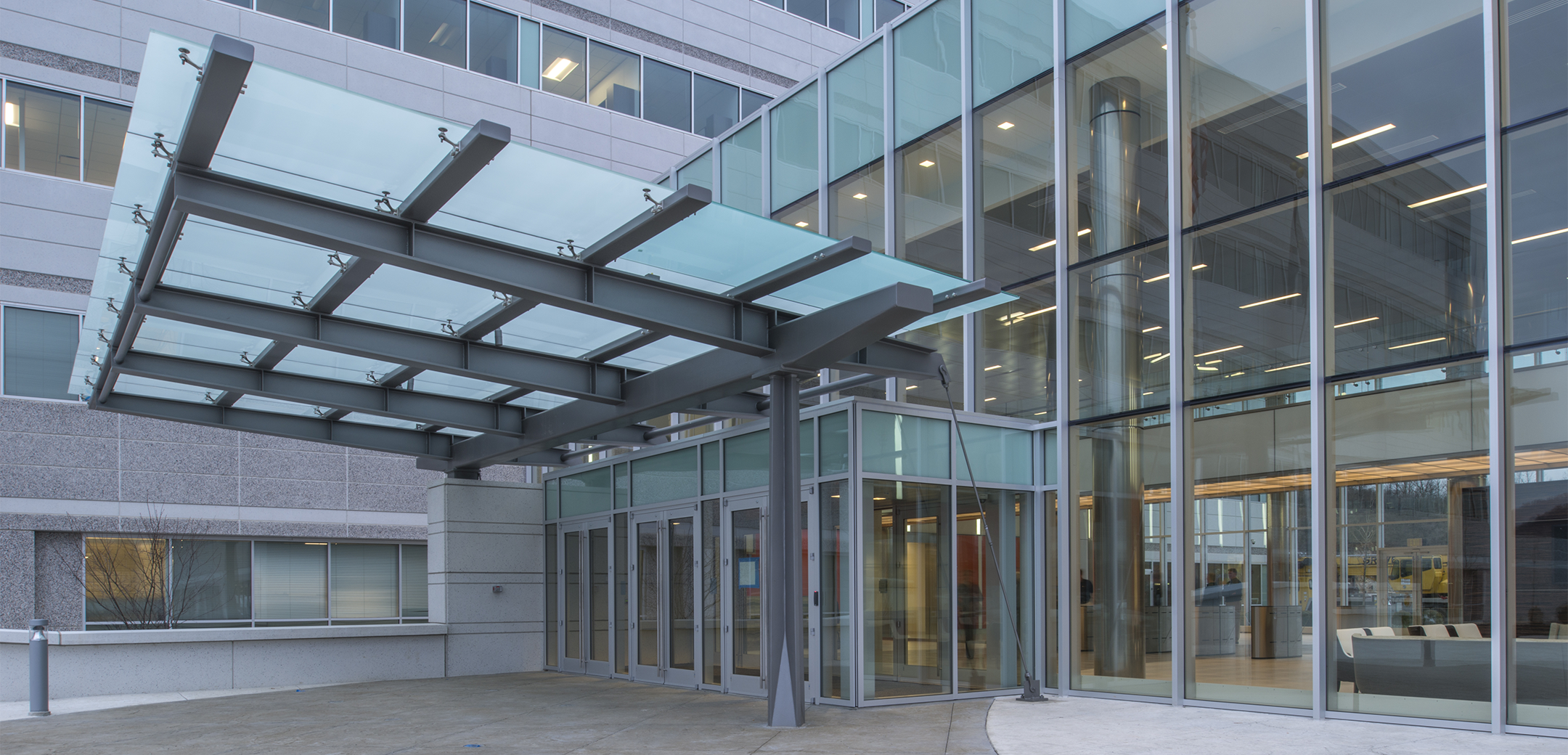 A close up of the glass connecting lobby and main entrance of the Endo pharmaceutical building.