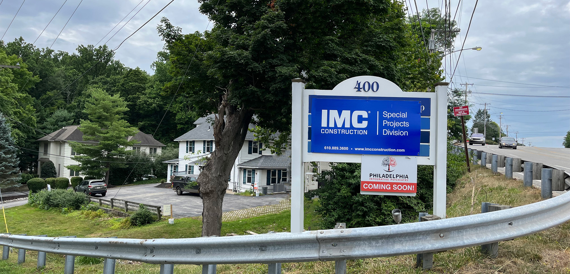 A blue sign that says "IMC Construction Special Projects Division" on the corner of the Philadelphia Integrative Psychiatry Office