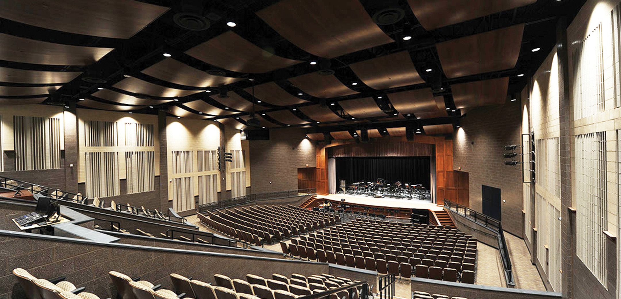 An interior view of the Phoenixville Middle School large auditorium from the upper level looking down towards the podium and floor level seating.