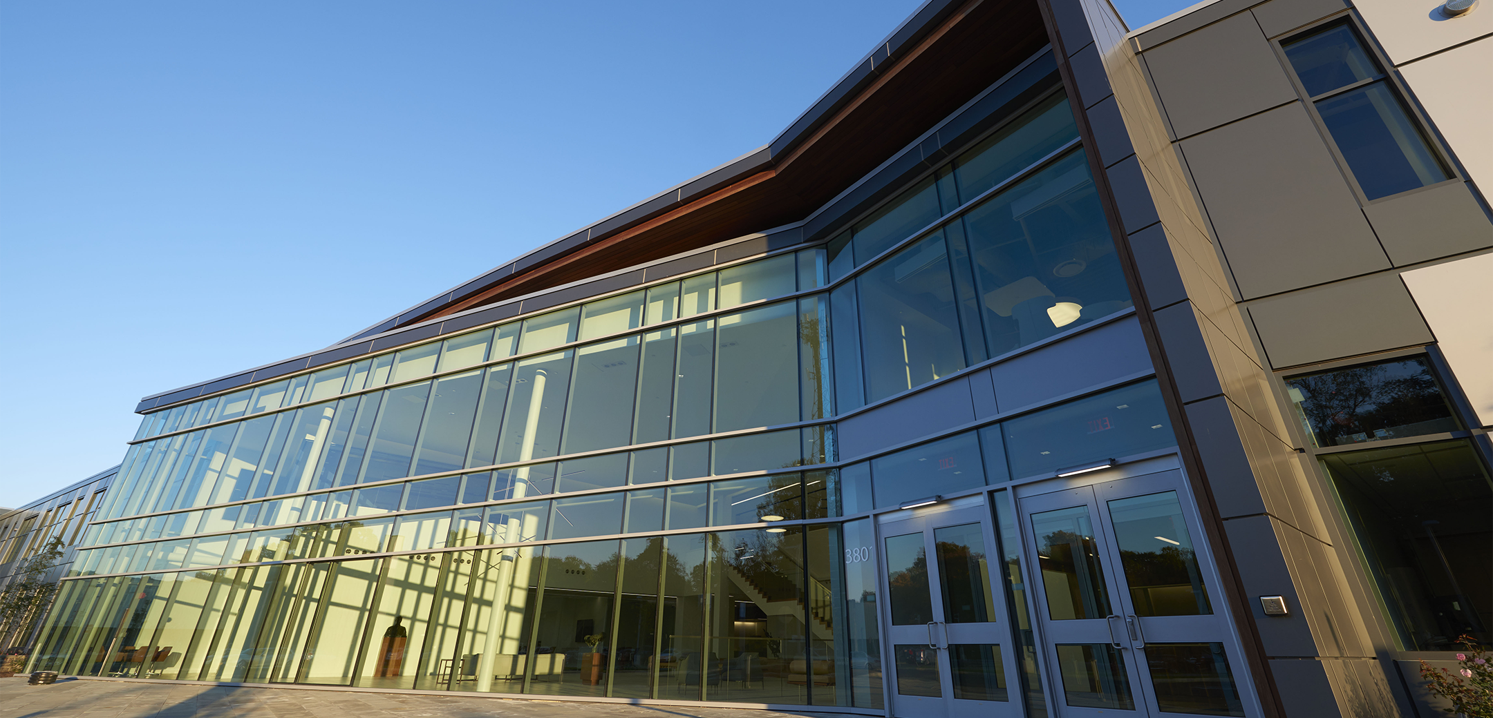 A close up of the Sunoco headquarters two story, kinked angle glass panel lobby entrance wall.