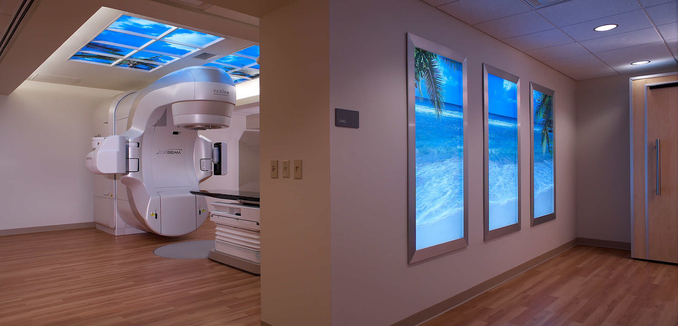 An interior view of the Abramson Cancer Center showcasing the view from the outside to the inside of the large medical inspection room with scanning equipment.