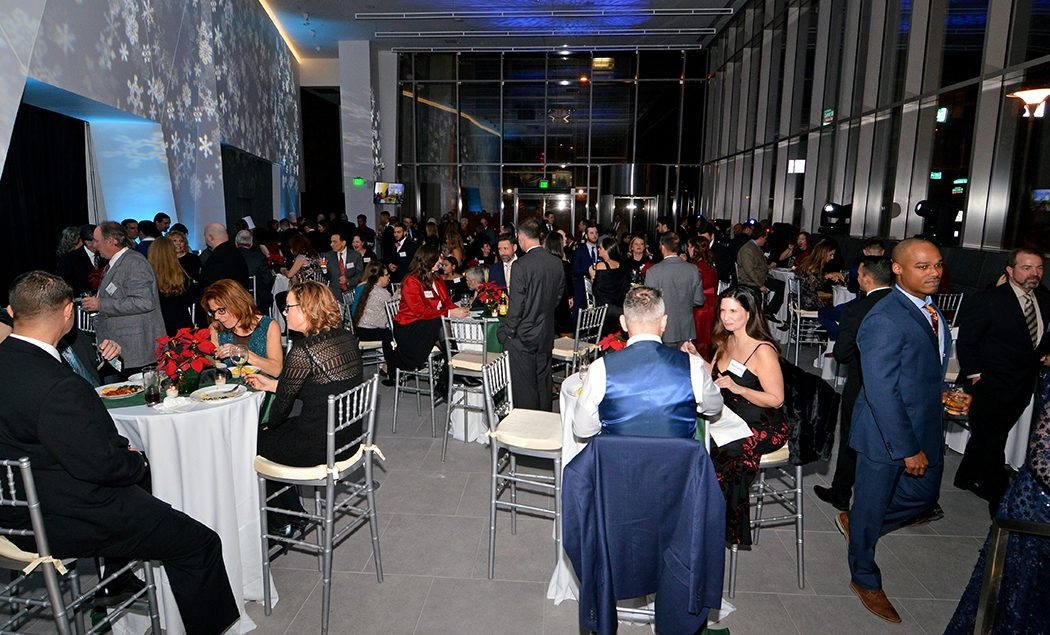 The Penn Medicine gala event with people in formal wear sitting at tables and watching a speaker.