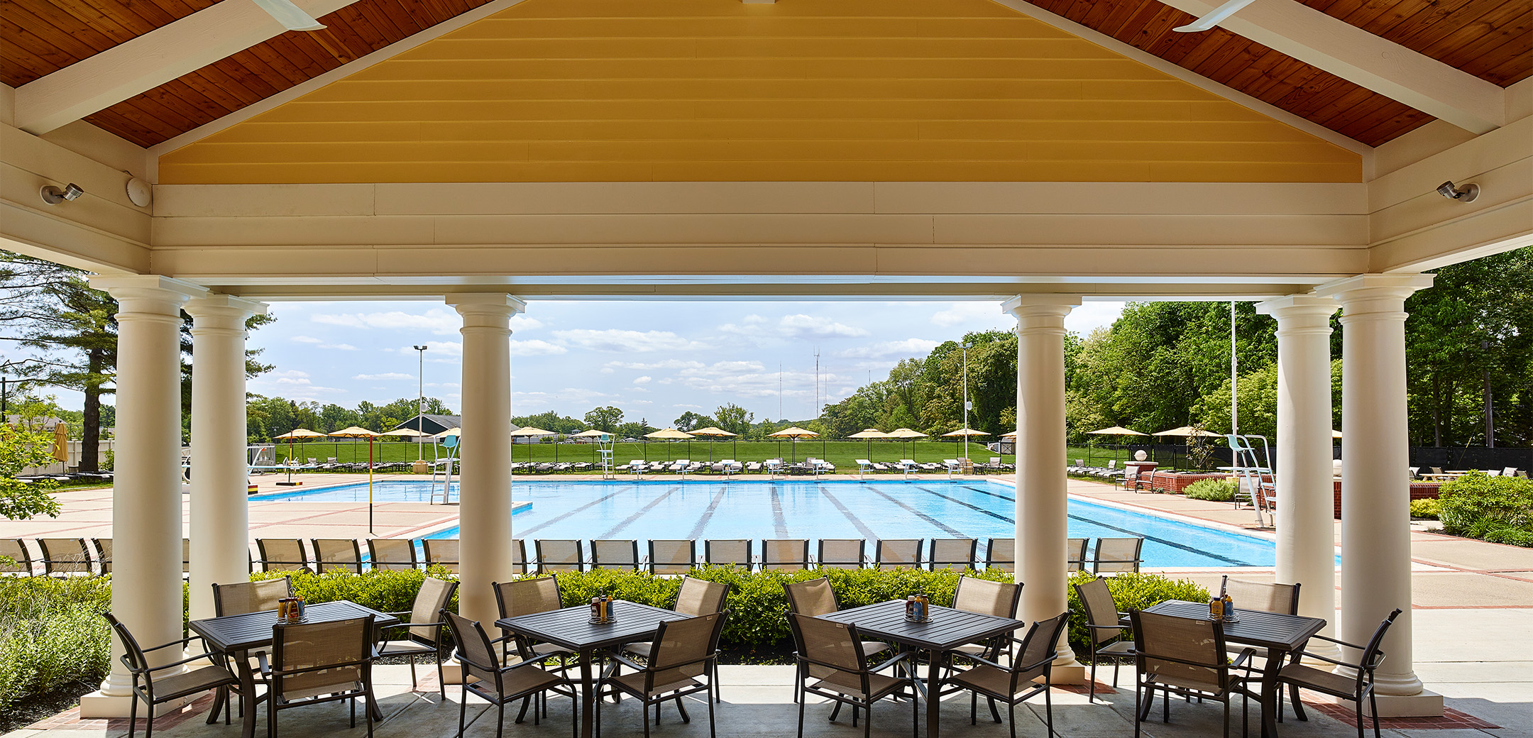 A close up view from the Philadelphia Cricket Club's Pool House / Pub with the large lap pool in the background.