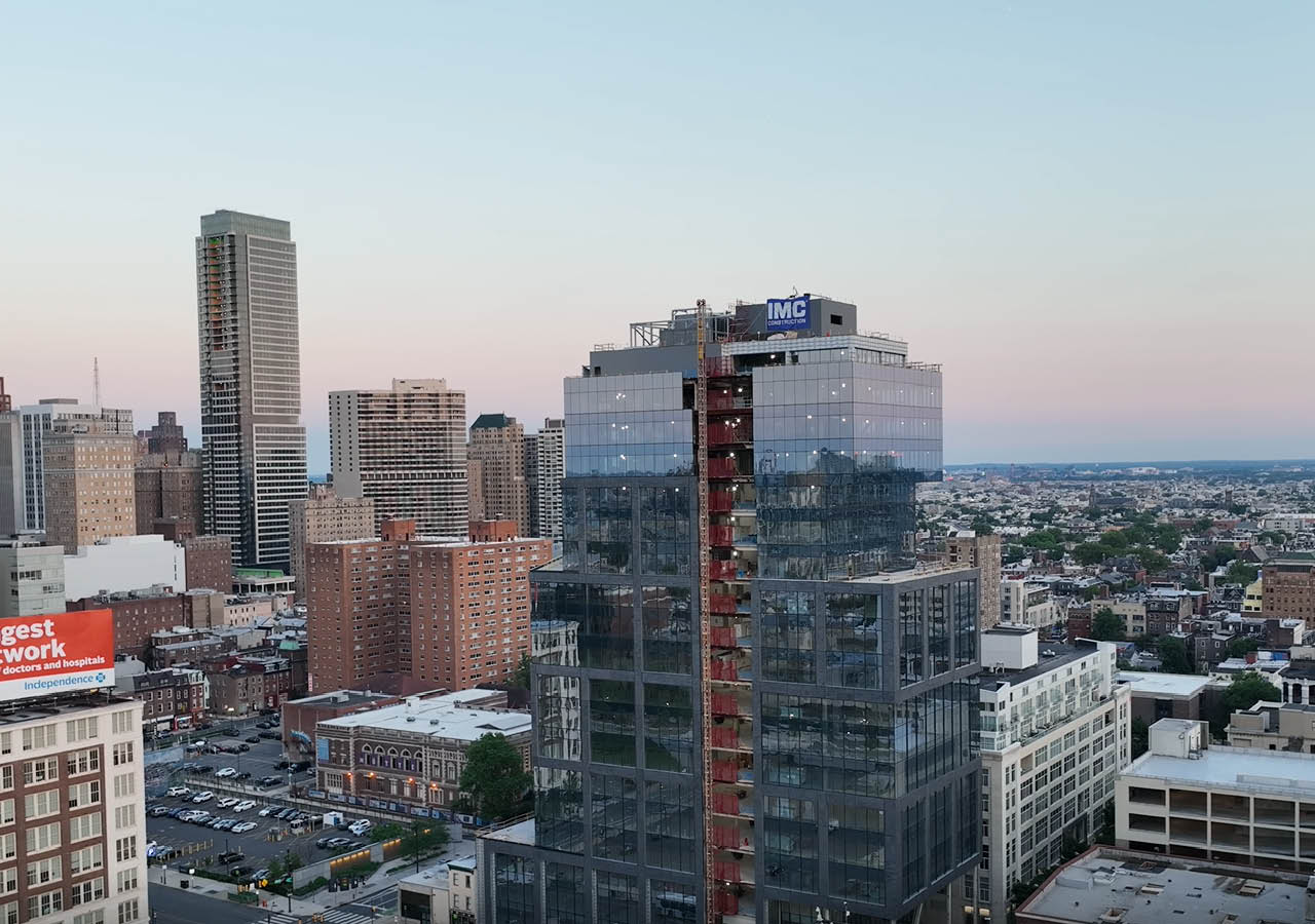 A drone shot of 2222 Market Street with the city of Philadelphia in the background