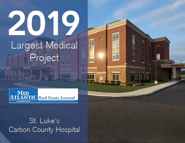An awards graphic featuring the 2019 Largest Medical Project signage, MAREJ logo placed on a half blue tinted image of St. Lukes Carbon County Hospital.