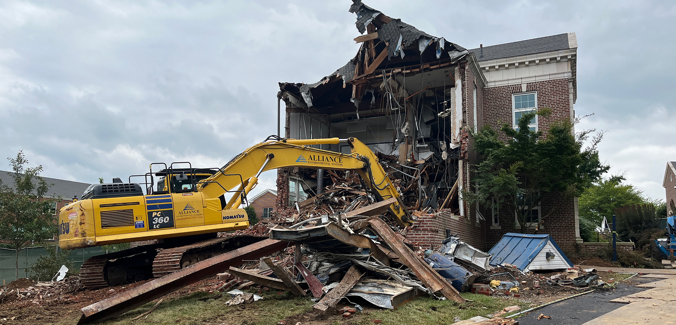 The Good Counsel Building on Malvern Preparatory's campus being being demolished with a yellow construction vehicle