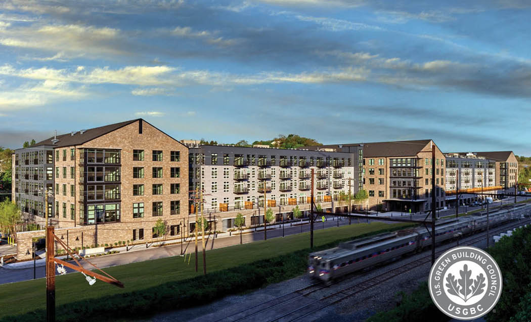 A drone shot of Matson Mill Apartments with a LEED certification logo